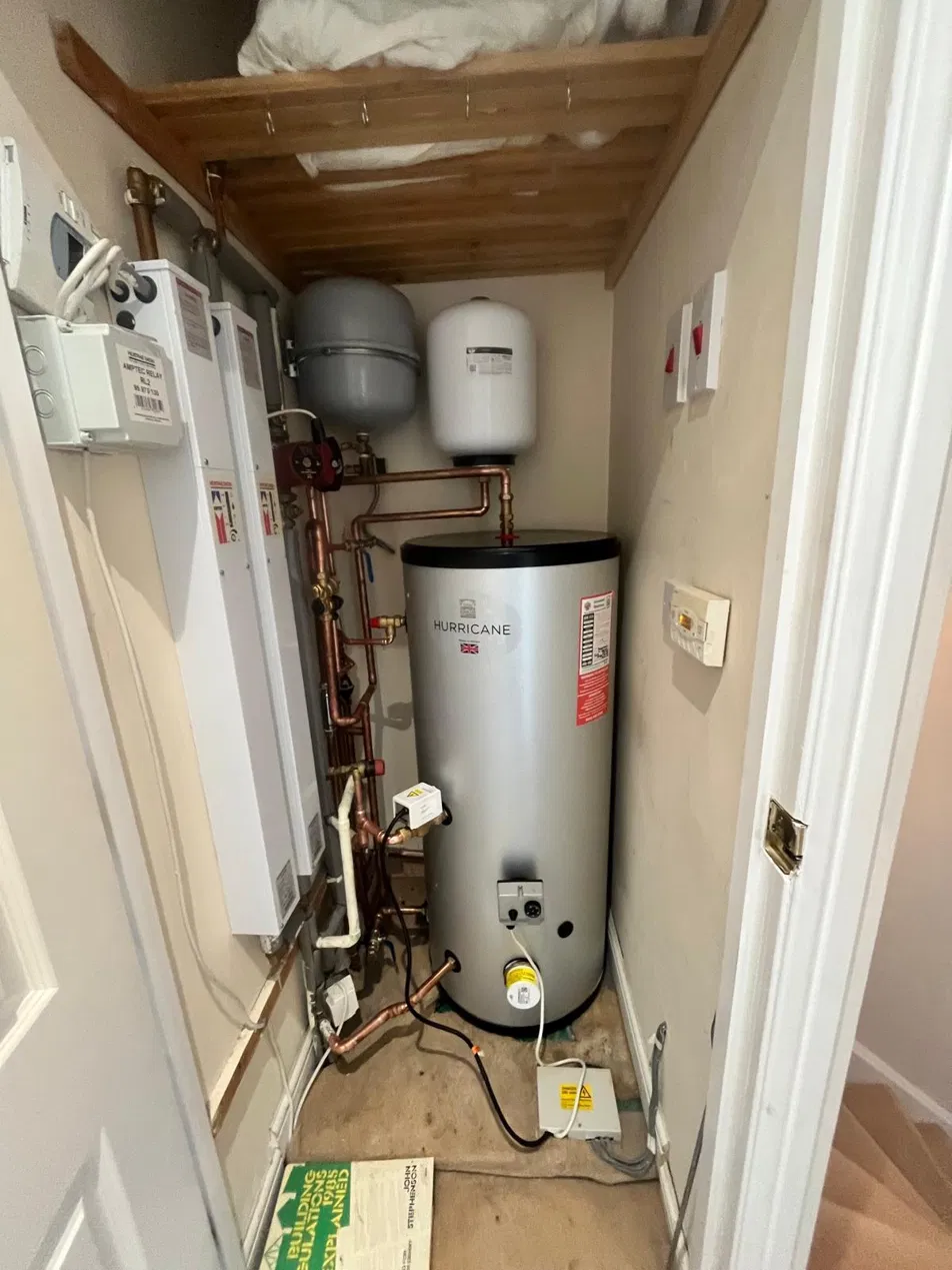 Unvented hot water cylinder with copper pipework and controls
